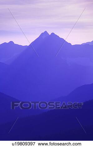 Stock Photo - Hazy layered mountain scene . Fotosearch