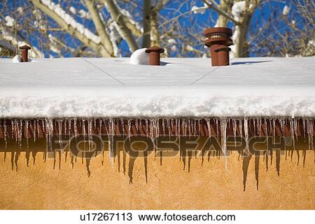 Icicles hanging from a roof View Large Photo Image Stock Image - Icicles hanging from a roof. Fotosearch