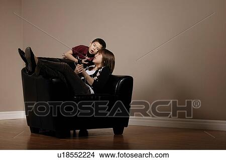 Little boy bothering his older sister View Large Photo Image Picture - Little boy bothering his older sister. Fotosearch