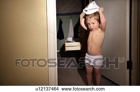 Picture - Little boy playing with underwear. Fotosearch