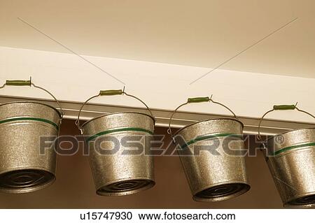 Stock Image - Low angle view of hanging buckets. Fotosearch