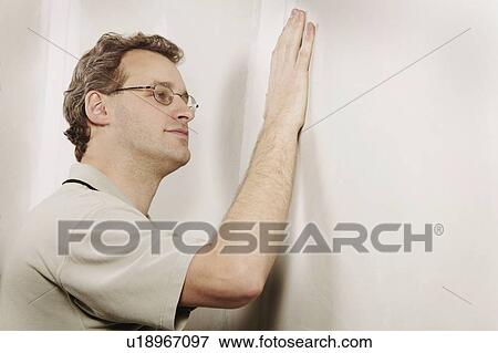 Man checking the smoothness of a wall View Large Photo Image Stock Photo - Man checking the smoothness of a wall. Fotosearch