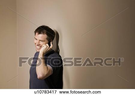 Man holding phone to ear View Large Photo Image Stock Photo - Man holding phone to ear. Fotosearch