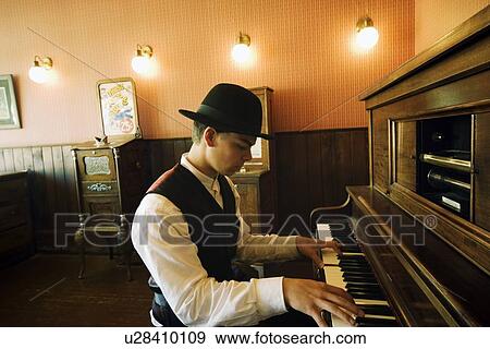 Stock Photo - Man playing vintage piano. Fotosearch