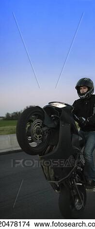Picture - Man riding a motorcycle. Fotosearch