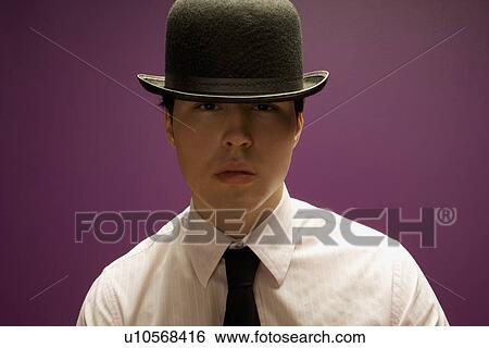 Man wearing a bowler hat View Large Photo Image Stock Photograph - Man wearing a bowler hat. Fotosearch