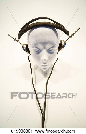 Stock Image - Mannequin head with headphones. Fotosearch