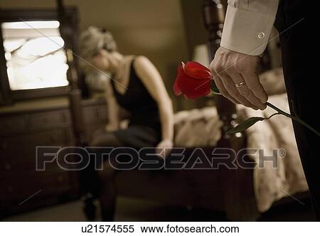 Stock Photography - Man's hand holding rose for woman. Fotosearch