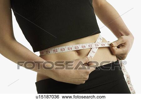 Stock Photograph - Measuring a waist-line. Fotosearch