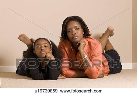Mom and daughter looking very serious View Large Photo Image Stock Photo - Mom and daughter looking very serious. Fotosearch