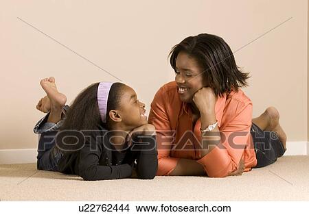 Mom and daughter relaxing together View Large Photo Image Picture - Mom and daughter relaxing together. Fotosearch