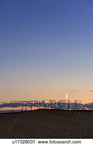 Stock Photo - Moonrise over fenceline . Fotosearch