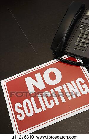 Stock Image - No soliciting sign with a telephone. Fotosearch