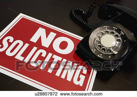 Stock Image - No soliciting sign with a telephone. Fotosearch