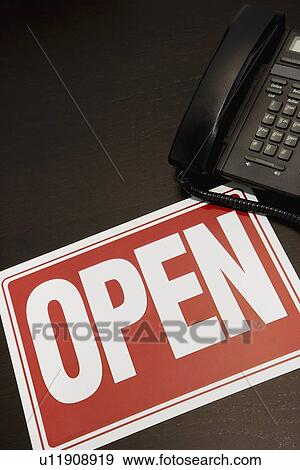 Stock Photo - Open sign with a telephone. Fotosearch