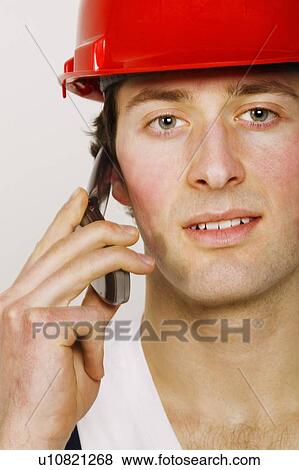 Portrait of a construction worker on the phone View Large Photo Image Stock Photo - Portrait of a construction worker on the phone. Fotosearch