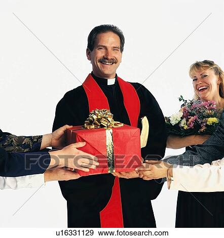 Priest receiving gifts View Large Photo Image Stock Photo - Priest receiving gifts. Fotosearch