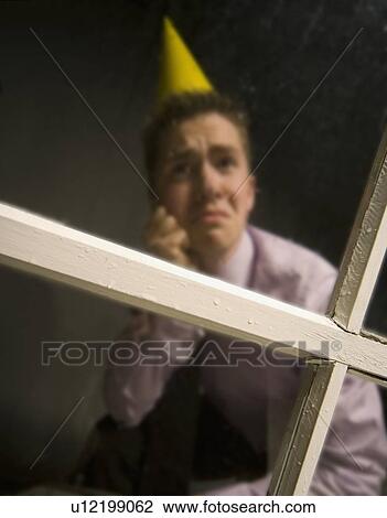 Sad man in party hat View Large Photo Image Stock Image - Sad man in party hat. Fotosearch