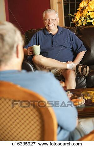 Senior man sitting and visiting with other senior man View Large Photo Image Stock Photo - Senior man sitting and visiting with other senior man. Fotosearch