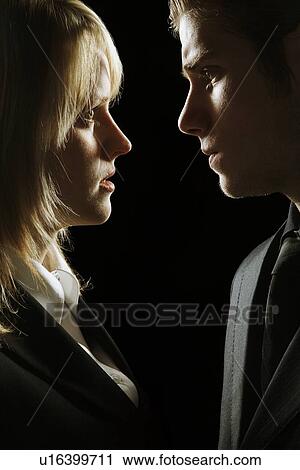 Side profile at a couple looking serious View Large Photo Image Stock Image - Side profile at a couple looking serious. Fotosearch