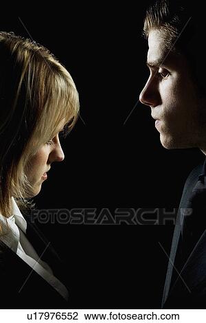 Side profile of a couple looking serious View Large Photo Image Stock Image - Side profile of a couple looking serious. Fotosearch