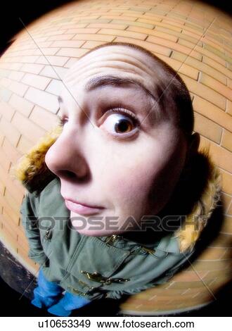 Stock Photo - Standing by brick wall. Fotosearch