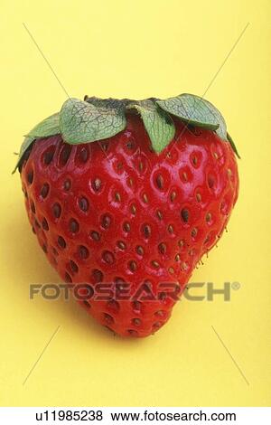 Stock Photo - Strawberry on yellow background. Fotosearch