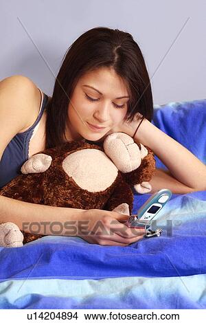 Teenager using a cell phone View Large Photo Image Picture - Teenager using a cell phone. Fotosearch