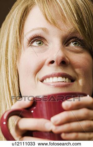 Woman holding a mug View Large Photo Image Stock Image - Woman holding a mug. Fotosearch