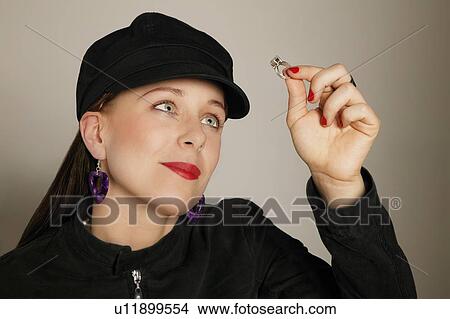 Picture - Woman holding a ring. Fotosearch