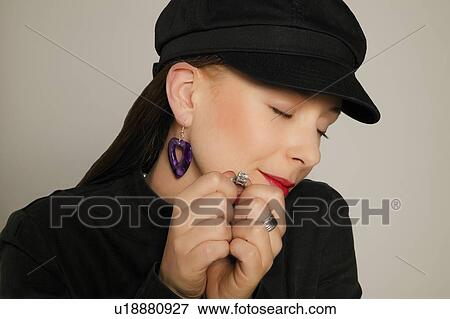 Stock Photo - Woman holding a ring. Fotosearch