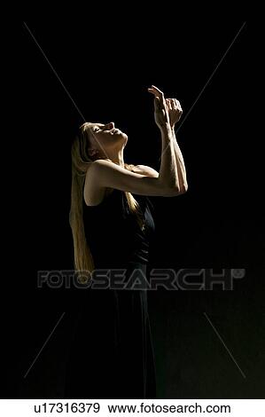 Stock Photo - Woman holding hands up. Fotosearch
