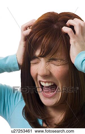 Woman holding head in anguish View Large Photo Image Stock Image - Woman holding head in anguish. Fotosearch