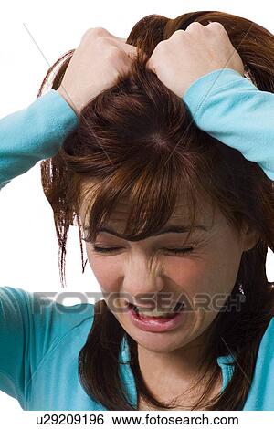Woman holding head in anguish View Large Photo Image Stock Photograph - Woman holding head in anguish. Fotosearch