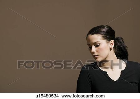 Picture - Woman looking downwards. Fotosearch