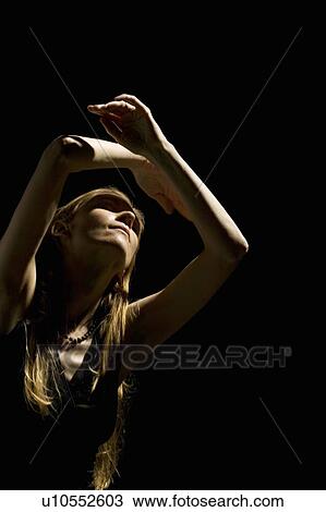 Woman looking up with arms raised over head View Large Photo Image Stock Image - Woman looking up with arms raised over head. Fotosearch