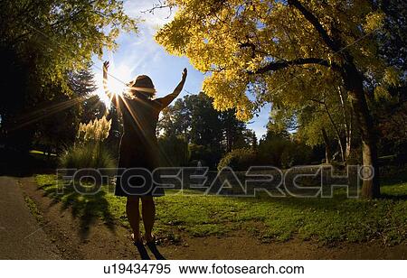 Stock Photography - Woman praying outdoors. Fotosearch