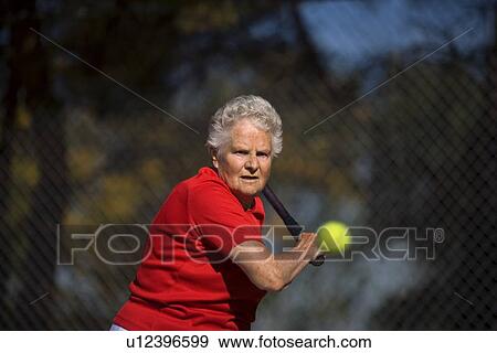 Woman ready to hit tennis ball View Large Photo Image Stock Photo - Woman ready to hit tennis ball. Fotosearch