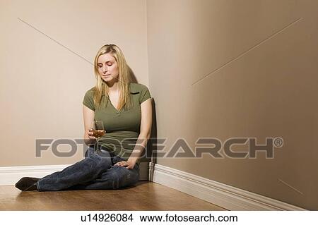 Picture - Woman sitting with wine glass. Fotosearch