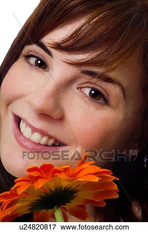 Stock Photo - Woman smiling with flower. Fotosearch