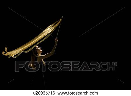 Stock Photograph - Woman waving flag in black background. Fotosearch