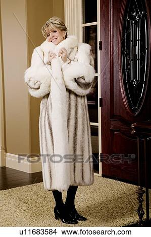 Woman wearing a fur coat View Large Photo Image Picture - Woman wearing a fur coat. Fotosearch