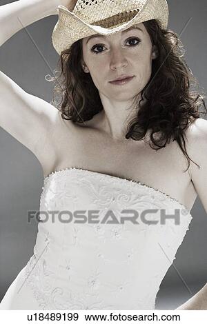 Woman wearing a wedding dress and cowboy hat View Large Photo Image Stock Photo - Woman wearing a wedding dress and cowboy hat. Fotosearch