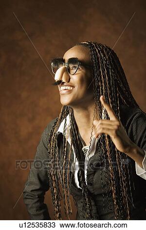 Stock Image - Woman with disguise. Fotosearch