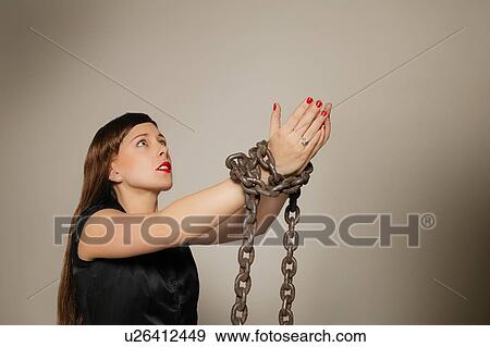 Stock Photo - Woman wrapped in a chain. Fotosearch