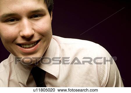 Young man smiling in shirt and tie View Large Photo Image Stock Image - Young man smiling in shirt and tie. Fotosearch
