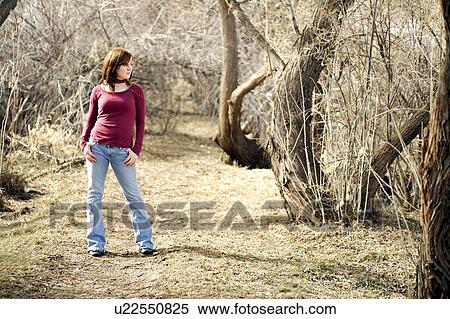 Stock Photography - Young woman posing in a wooded area. Fotosearch