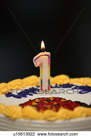 A birthday cake with lit candle View Large Photo Image Stock Image - A birthday cake with lit candle . Fotosearch