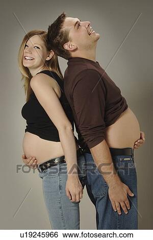 Stock Photograph - A couple with growing bellies. Fotosearch