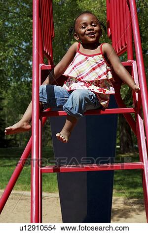 Picture - A girl on a slide. Fotosearch